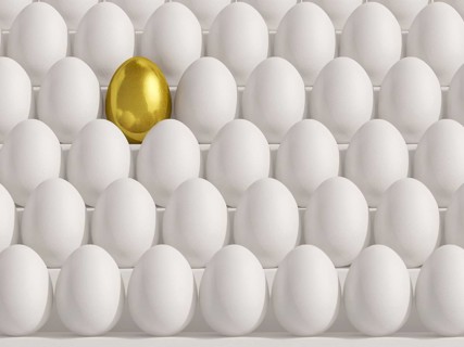 Golden egg amidst white eggs