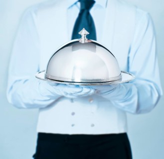 Waiter holding a cloche