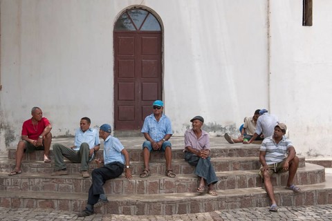 Men meeting on the steps of the church Cha de Igreja