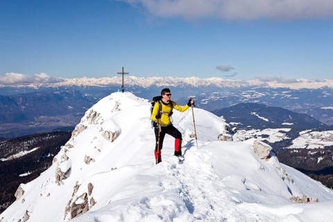 Winter hiker on the summit ridge while descending from Weisshorn Mountain on Jochgrimm Pass