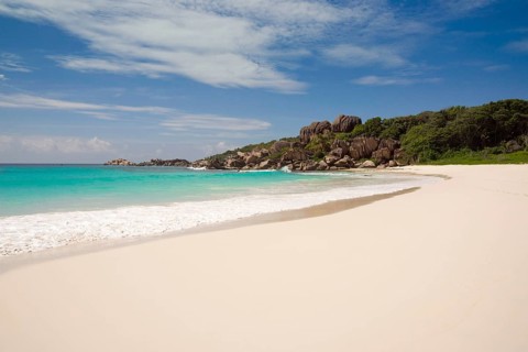 Sandy beach with the rock formations typical for the Seychelles