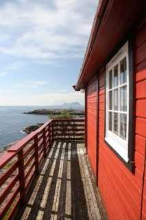 Typical Norwegian red wooden house by the sea