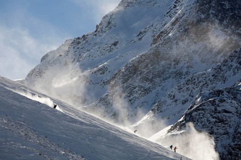 Skiers going downhill