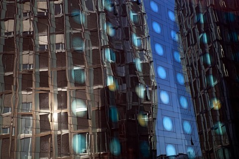 Tanzende Turme office building reflected in the facade of the Arcotel Onyx Hotel