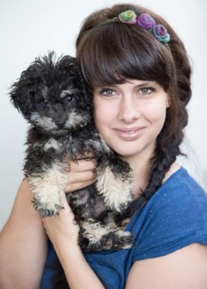 Young woman holding a Toy Poodle