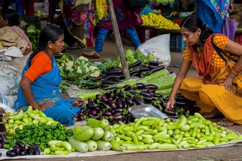 A woman is selling aubergines