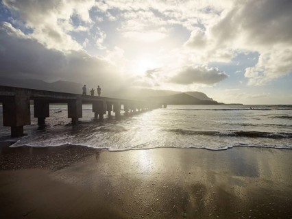Family walking on a pier