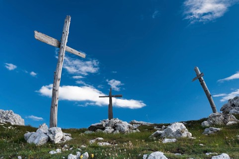 Three simple wooden crosses from World War I on a hill