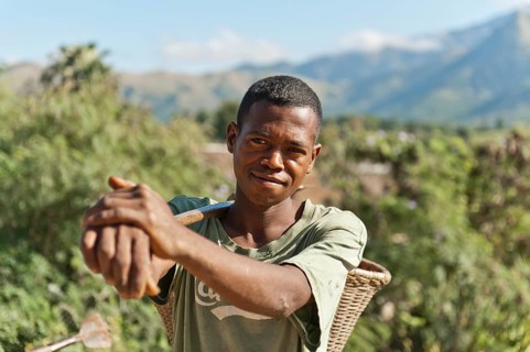 Young man of the Antandroy people carrying a basket for field work