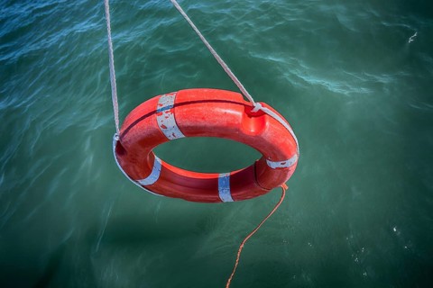 Lifebuoy dangling over water