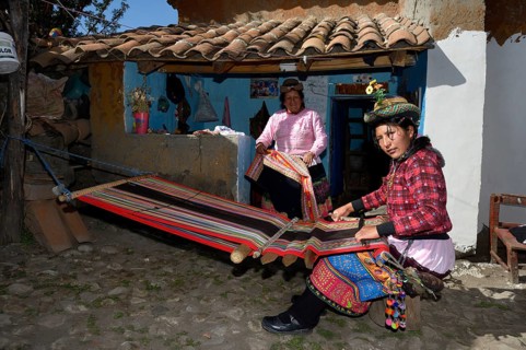 Young woman weaving traditional cloth at the loom