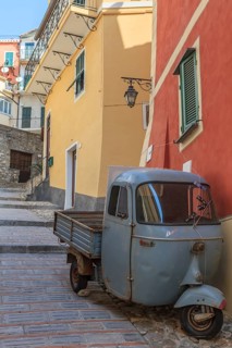 Typical Italian three-wheeled light commercial vehicle parked in an alley