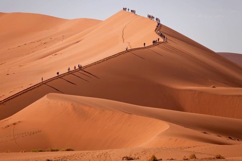 Tourists climbing the Sossusvlei Dunes