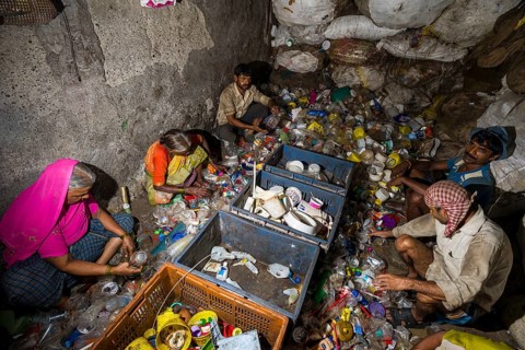 Workers sorting out plastic garbage for recycling