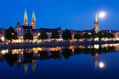 Trave river and the historic centre at full moon