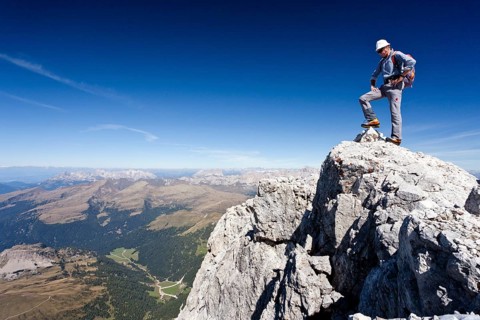Mountain climber on the summit of Cima di Vezzana Mountain