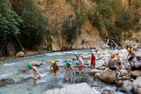 Tourists crossing the river