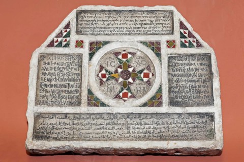Stone with inscriptions in four languages