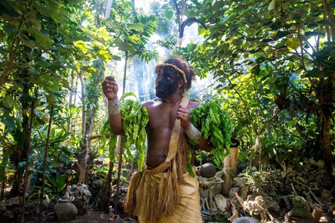 Traditional dressed man with black face in the jungle