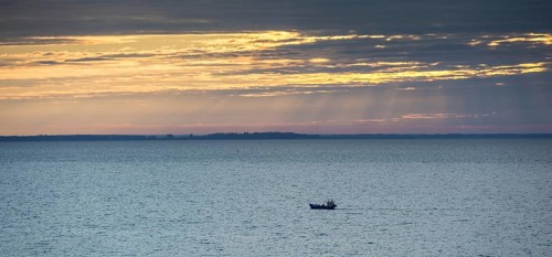 Fishing boat on the Curonian Lagoon at sunrise