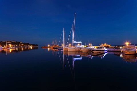 Boats reflected in the water at night