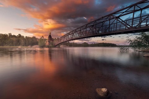 Bridge and Church of St. Andrew at Vuoksi River during sunset
