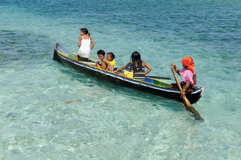 Kuna Indians in a dugout canoe