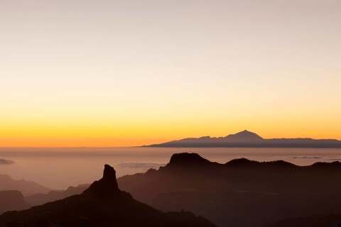 Rock formation of Roque Bentayga in front of Tenerife with Mount Teide