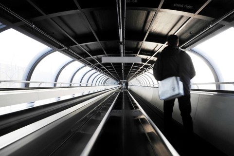 Moving sidewalk in oval tunnel connecting exhibition halls on fair ground