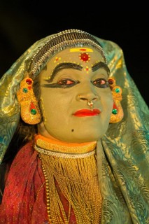 Kathakali dancer in full makeup wearing a costume