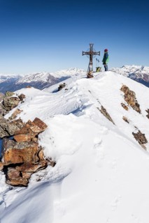 Climber on the summit of Mt Penser Weisshorn