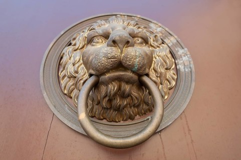 Lion head door knocker on a door of a house