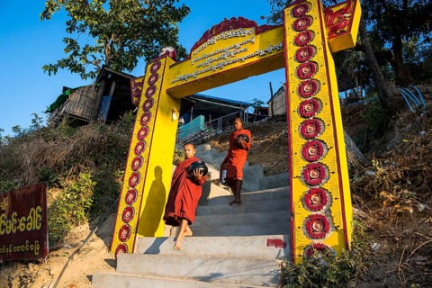 Buddhist novices with begging bowls at their morning begging tour