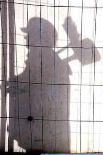 Shadow of a construction worker on a concrete wall