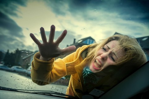 Young woman hitting the windshield of a car during an accident