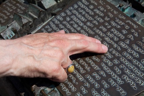 Male fingers reading braille