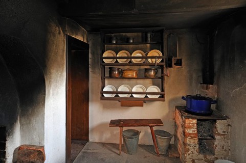 Kitchen of a farmhouse with soot-blackened walls