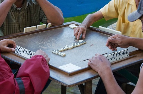 Four men playing dominoes