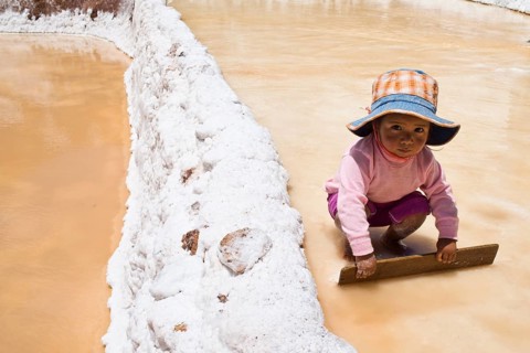 Child playing with a wooden board