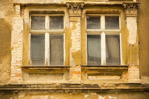 Window of a closed down hotel in need of refurbishment
