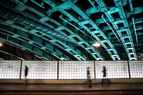 Pedestrians in an illuminated underpass