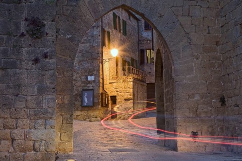 City gate with the light trace of a passing car