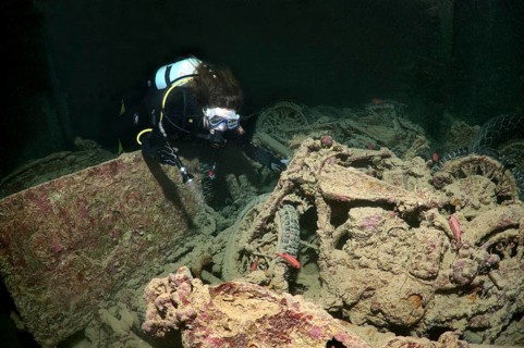 Scuba diver looking at Norton 16H motorcycle