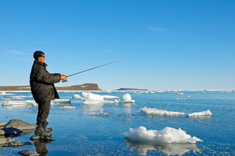 Man of the Inuit people fishing on the banks of the Beaufort Sea