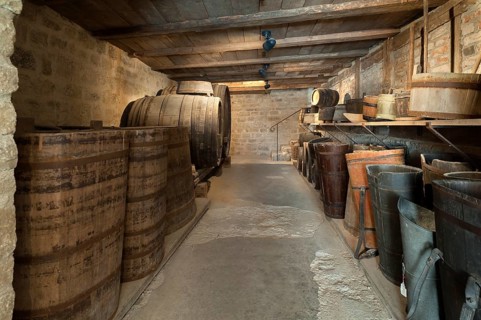 Old wine cellar with barrels of a winery