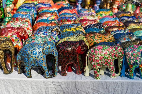 Colourful papier mache elephants for sale at the weekly flea market