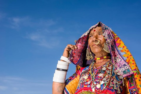 Old woman belonging to the local tribe of Lambani wearing the traditional colorful dress