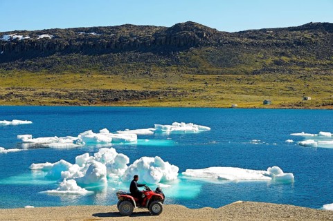 Man of the Inuit people riding a quad bike
