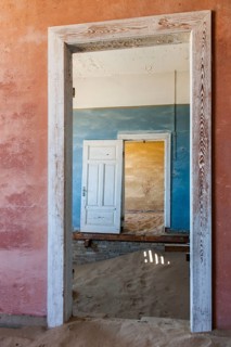 Wind-borne sand in a house of the former diamond miners settlement that is slowly covered by the sand of the Namib Desert