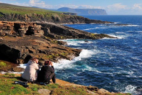 Two female tourists on the lookout with binoculars